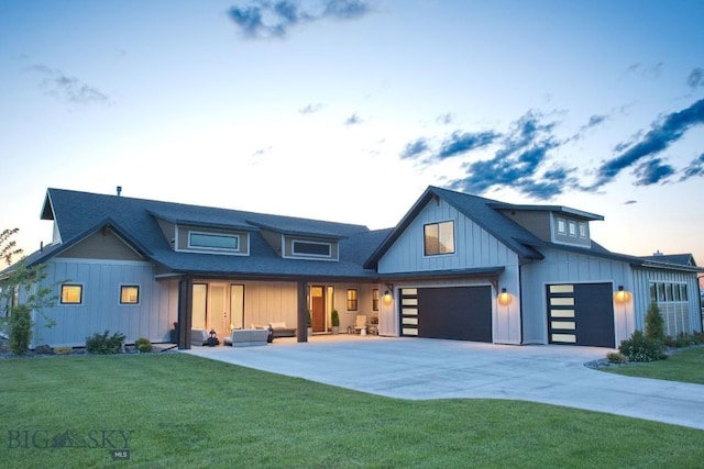 243 Tinkers Ln, Bozeman, MT 59718 - modern farmhouse featuring a lawn, board and batten siding, driveway, a garage, and a shingled roof