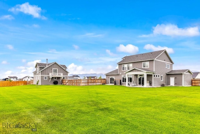 1484 Stewart Loop, Bozeman, MT 59718 - back of property with a fenced backyard, a patio area, and a shingled roof