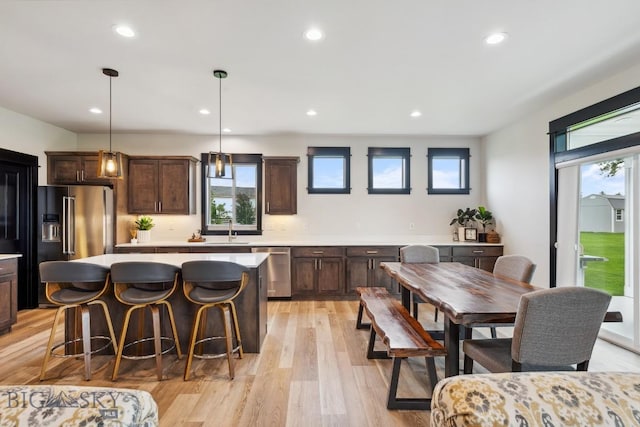 1484 Stewart Loop, Bozeman, MT 59718 - kitchen featuring high end fridge, stainless steel dishwasher, dark brown cabinetry, light countertops, and a center island