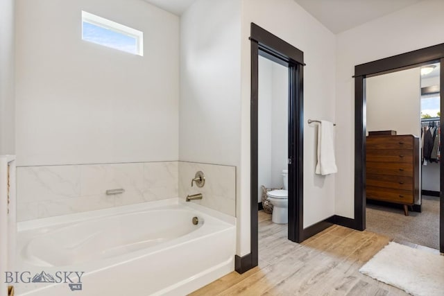 1484 Stewart Loop, Bozeman, MT 59718 - full bathroom featuring a garden tub, wood finished floors, and a walk in closet