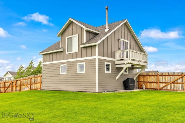 1484 Stewart Loop, Bozeman, MT 59718 - rear view of house with board and batten siding, roof with shingles, a fenced backyard, and a balcony