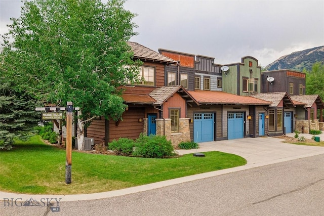 99 Pheasant Tail Ln Unit 1, Big Sky, MT 59716 - view of front of property with driveway, a front lawn, and stone siding