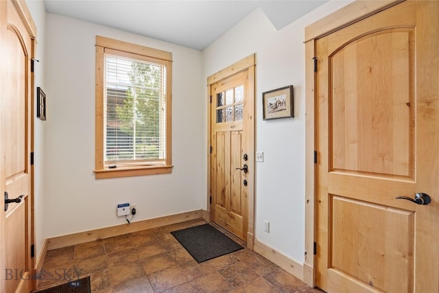 99 Pheasant Tail Ln Unit 1, Big Sky, MT 59716 - foyer with baseboards and stone finish flooring