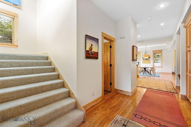 99 Pheasant Tail Ln Unit 1, Big Sky, MT 59716 - hallway with stairs, light wood finished floors, and recessed lighting