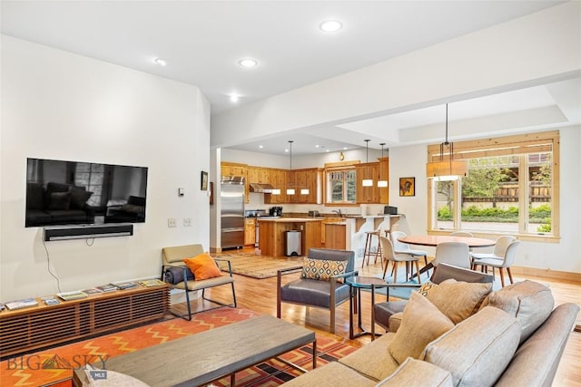 99 Pheasant Tail Ln Unit 1, Big Sky, MT 59716 - living area featuring light wood-style flooring, recessed lighting, and a raised ceiling