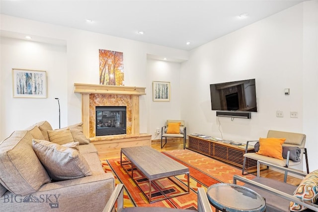 99 Pheasant Tail Ln Unit 1, Big Sky, MT 59716 - living room with a high end fireplace, recessed lighting, and wood finished floors