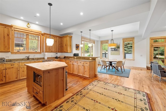 99 Pheasant Tail Ln Unit 1, Big Sky, MT 59716 - kitchen with wooden counters, a peninsula, light wood-style floors, a kitchen island, and recessed lighting