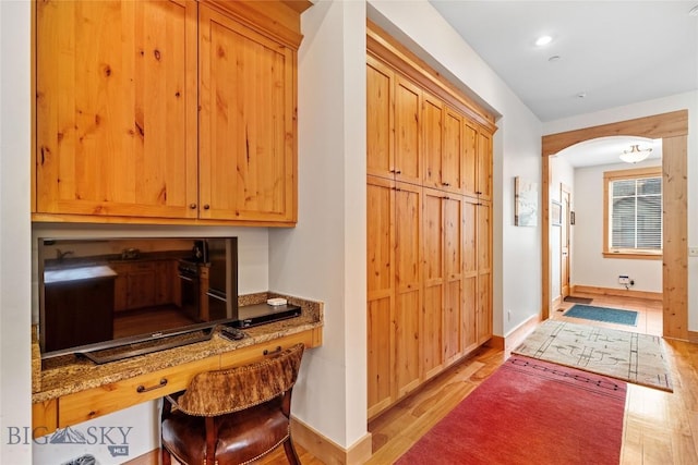 99 Pheasant Tail Ln Unit 1, Big Sky, MT 59716 - office with arched walkways and light wood-style flooring