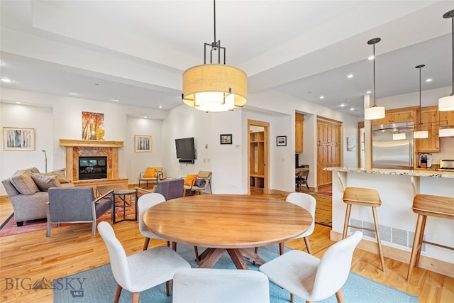 99 Pheasant Tail Ln Unit 1, Big Sky, MT 59716 - dining space with light wood-type flooring, recessed lighting, and a high end fireplace
