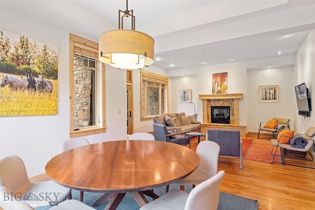 99 Pheasant Tail Ln Unit 1, Big Sky, MT 59716 - dining space with light wood finished floors, a premium fireplace, and recessed lighting