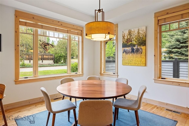99 Pheasant Tail Ln Unit 1, Big Sky, MT 59716 - dining space featuring wood finished floors and healthy amount of natural light