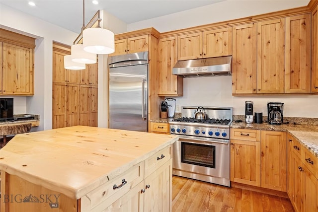 99 Pheasant Tail Ln Unit 1, Big Sky, MT 59716 - kitchen featuring premium appliances, under cabinet range hood, light wood-style floors, a center island, and recessed lighting