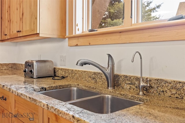 99 Pheasant Tail Ln Unit 1, Big Sky, MT 59716 - kitchen view of light stone countertops and light brown cabinetry