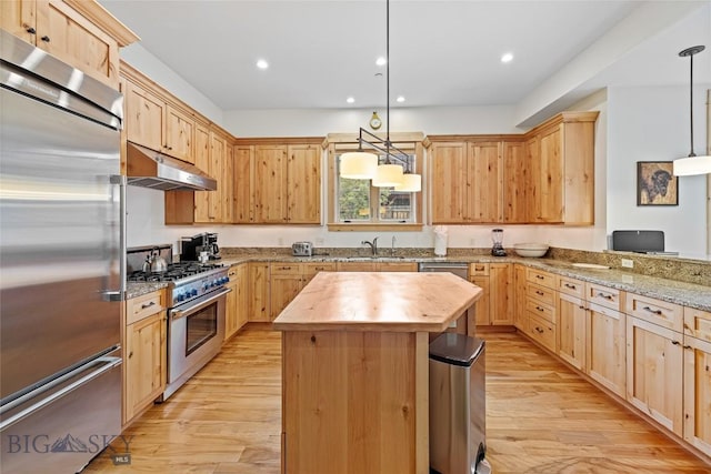 99 Pheasant Tail Ln Unit 1, Big Sky, MT 59716 - kitchen with premium appliances, under cabinet range hood, light brown cabinetry, wooden counters, and recessed lighting