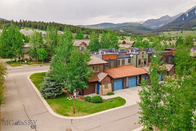99 Pheasant Tail Ln Unit 1, Big Sky, MT 59716 - view of front of property featuring a mountain view, driveway, a garage, and a residential view