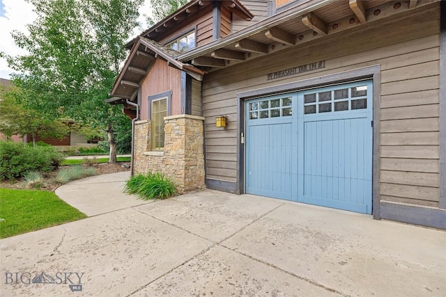 99 Pheasant Tail Ln Unit 1, Big Sky, MT 59716 - entrance to property with concrete driveway and stone siding