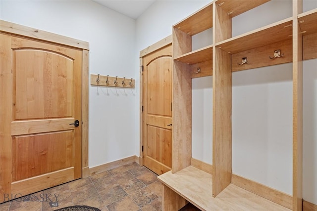99 Pheasant Tail Ln Unit 1, Big Sky, MT 59716 - mudroom with dark stone finish flooring and baseboards