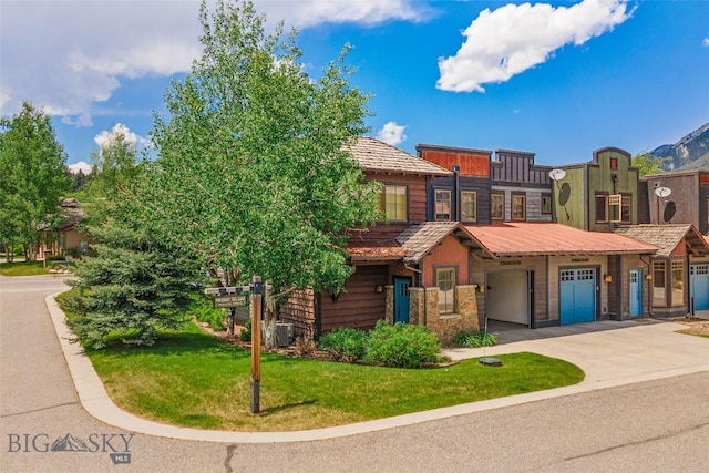 99 Pheasant Tail Ln Unit 1, Big Sky, MT 59716 - view of front of property featuring driveway, a front yard, and a garage