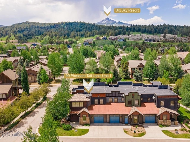 99 Pheasant Tail Ln Unit 1, Big Sky, MT 59716 - aerial perspective of suburban area featuring mountains and a forest
