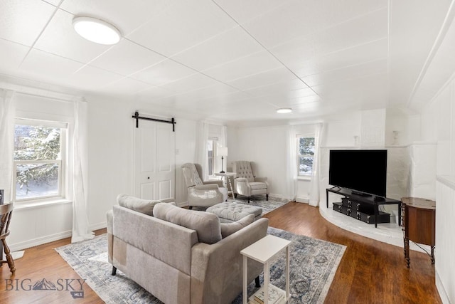 12977 Cottonwood Rd, Bozeman, MT 59718 - living room with a barn door and wood finished floors