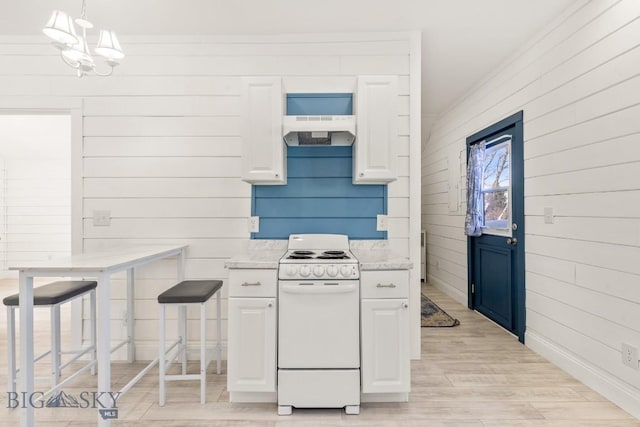 12977 Cottonwood Rd, Bozeman, MT 59718 - kitchen with electric stove, under cabinet range hood, light wood-type flooring, white cabinets, and wooden walls