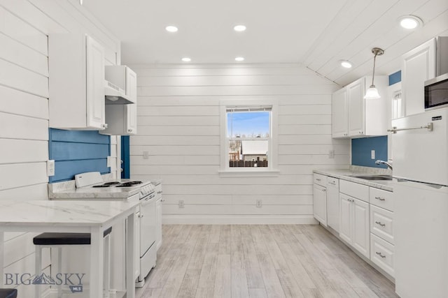 12977 Cottonwood Rd, Bozeman, MT 59718 - kitchen featuring white appliances, white cabinets, light wood-type flooring, recessed lighting, and light stone countertops