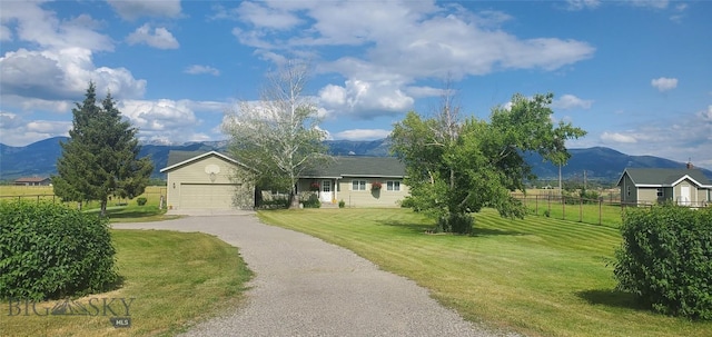 ranch-style home with a mountain view, driveway, and an attached garage