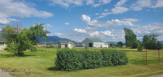 view of yard with a mountain view and a view of rural / pastoral area