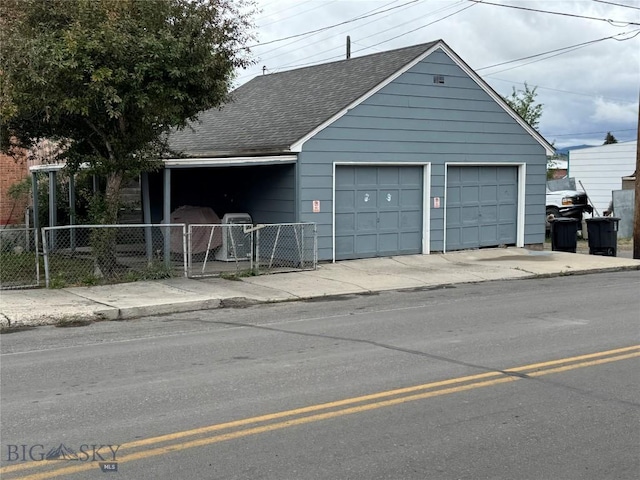 1001 Utah Ave, Butte, MT 59701 - view of front of home featuring a garage, a shingled roof, an outdoor structure, and a gate