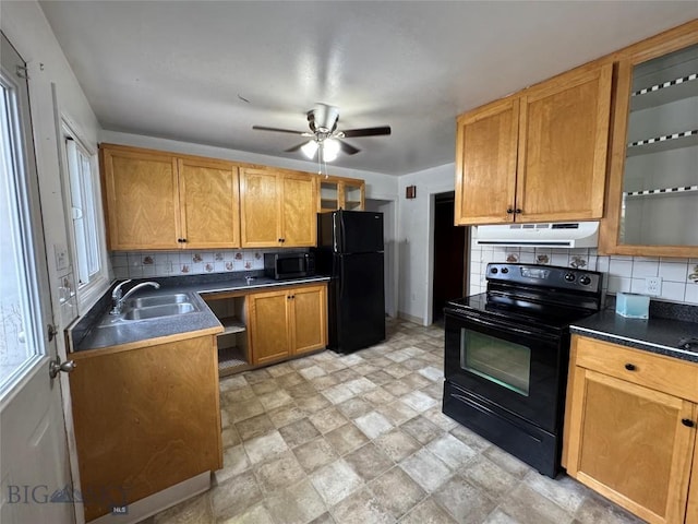 1001 Utah Ave, Butte, MT 59701 - kitchen featuring black appliances, under cabinet range hood, backsplash, and dark countertops