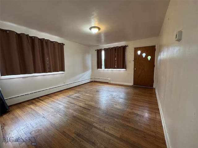 1001 Utah Ave, Butte, MT 59701 - empty room with baseboard heating and dark wood-style floors