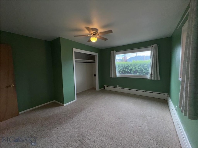 1001 Utah Ave, Butte, MT 59701 - unfurnished bedroom featuring a baseboard radiator, carpet, a closet, and ceiling fan