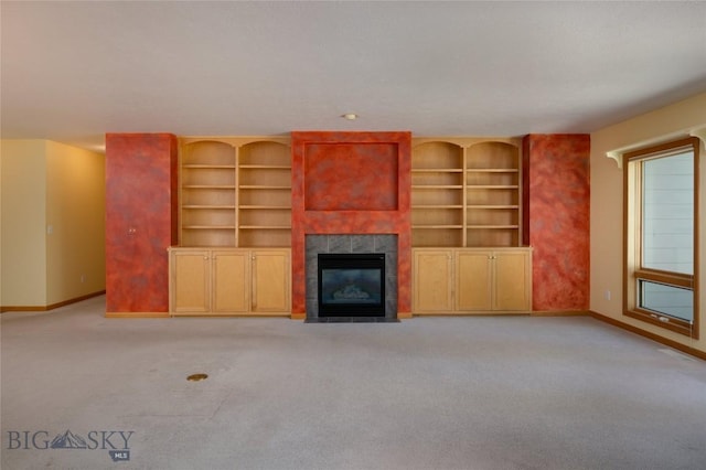 2400 Durston Rd Unit 17, Bozeman, MT 59718 - unfurnished living room with a tile fireplace, light carpet, and built in shelves