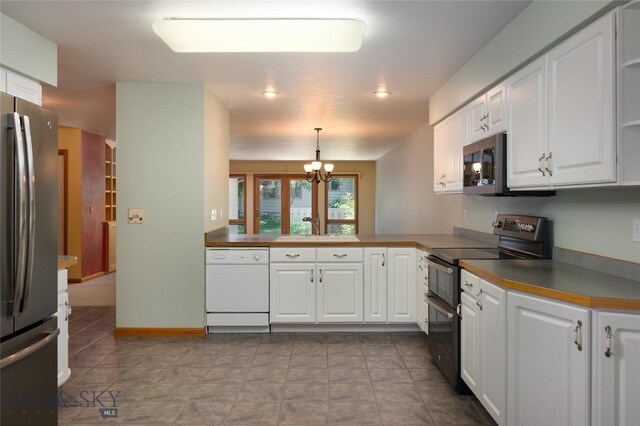 2400 Durston Rd Unit 17, Bozeman, MT 59718 - kitchen with appliances with stainless steel finishes, white cabinetry, a chandelier, and dark countertops