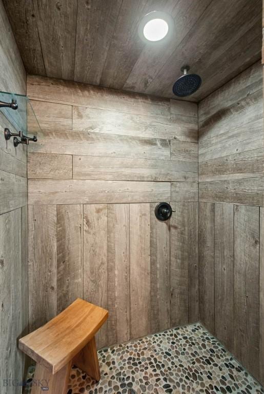 185 Peak, Bozeman, MT 59715 - bathroom featuring tiled shower, wood ceiling, and wood walls