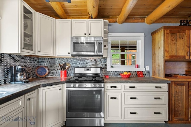 185 Peak, Bozeman, MT 59715 - kitchen featuring appliances with stainless steel finishes, a wooden ceiling with exposed beams, tasteful backsplash, glass insert cabinets, and dark countertops