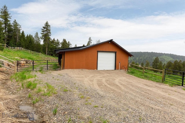 185 Peak, Bozeman, MT 59715 - detached garage with a forest view, dirt driveway, and a rural view