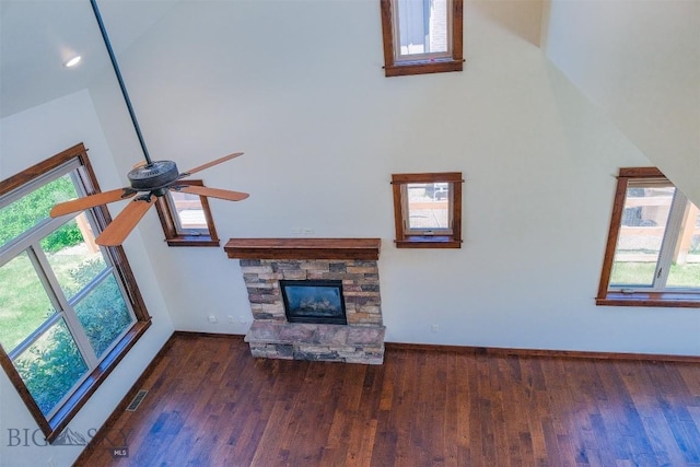 3230 S 26th Ave, Bozeman, MT 59718 - unfurnished living room featuring ceiling fan, plenty of natural light, wood finished floors, and a stone fireplace