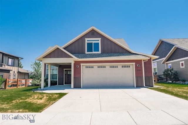 3230 S 26th Ave, Bozeman, MT 59718 - view of front of property featuring board and batten siding, a front lawn, driveway, and a shingled roof