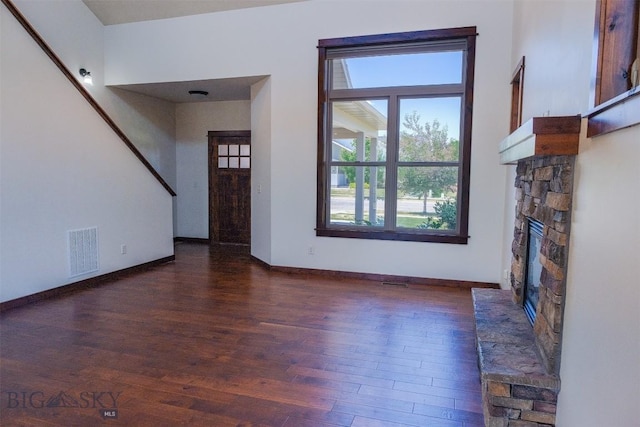 3230 S 26th Ave, Bozeman, MT 59718 - unfurnished living room with a stone fireplace and wood finished floors