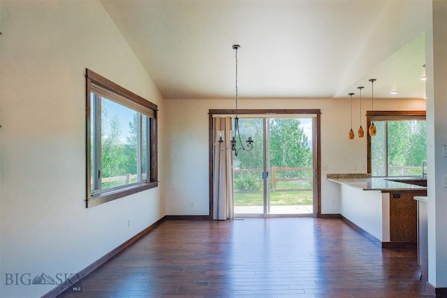 3230 S 26th Ave, Bozeman, MT 59718 - unfurnished dining area featuring dark wood-style floors, plenty of natural light, vaulted ceiling, and a chandelier