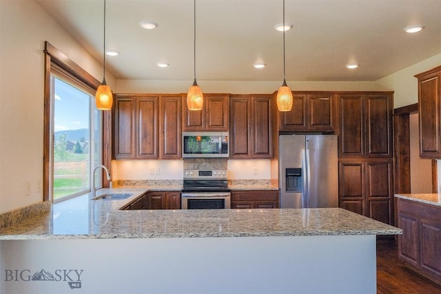 3230 S 26th Ave, Bozeman, MT 59718 - kitchen featuring appliances with stainless steel finishes, light stone counters, a peninsula, decorative light fixtures, and recessed lighting