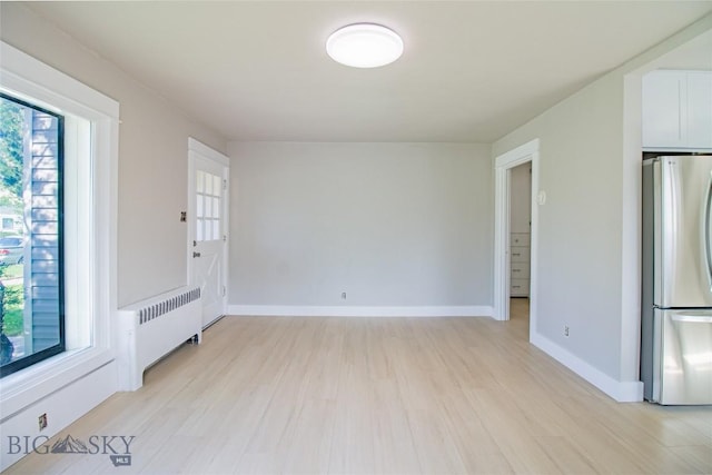 1940 Locust, Butte, MT 59701 - empty room featuring radiator and light wood finished floors
