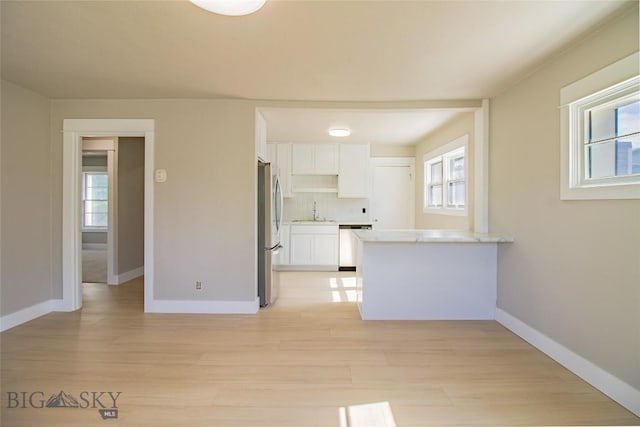 1940 Locust, Butte, MT 59701 - unfurnished living room with a sink and light wood finished floors