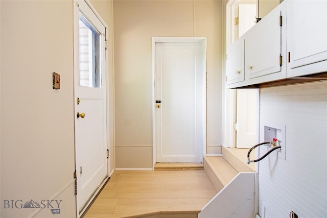 1940 Locust, Butte, MT 59701 - washroom featuring cabinet space, washer hookup, and light wood-style floors