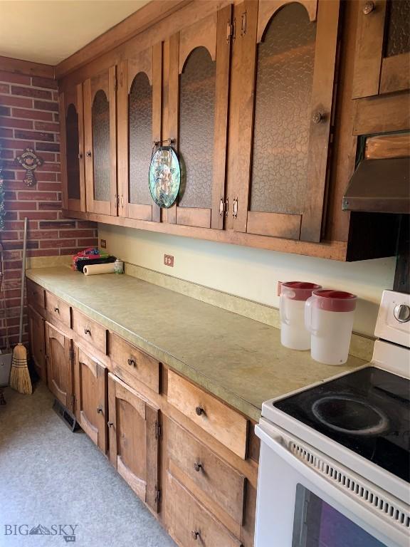 1813 Adams Ave, Butte, MT 59701 - kitchen with electric stove, extractor fan, and light countertops