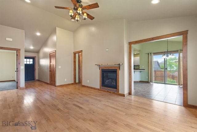 901 Floyd Way, Livingston, MT 59047 - unfurnished living room featuring a ceiling fan, lofted ceiling, light wood-style flooring, a glass covered fireplace, and recessed lighting