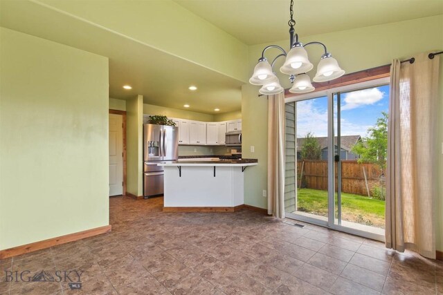 901 Floyd Way, Livingston, MT 59047 - kitchen featuring appliances with stainless steel finishes, a chandelier, white cabinets, a peninsula, and hanging light fixtures