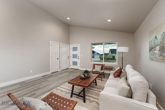 2204 Oriole Dr, Belgrade, MT 59714 - living area featuring light wood finished floors, vaulted ceiling, and recessed lighting