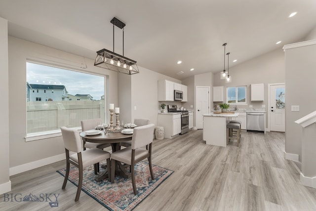2204 Oriole Dr, Belgrade, MT 59714 - dining room with light wood-style flooring, recessed lighting, high vaulted ceiling, and a chandelier